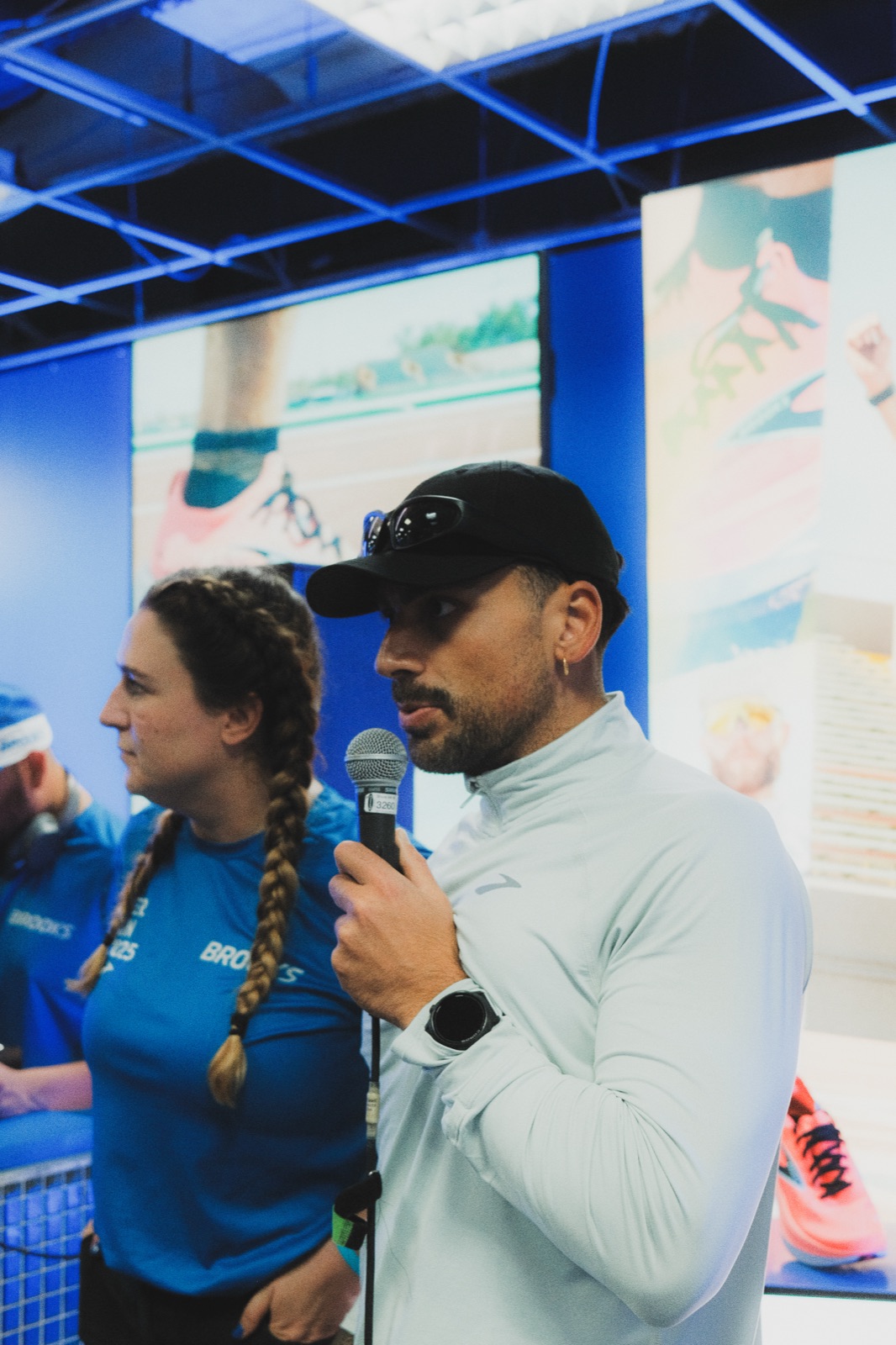 Sertan on mic at Brooks Hyperion House Berlin Marathon 2025